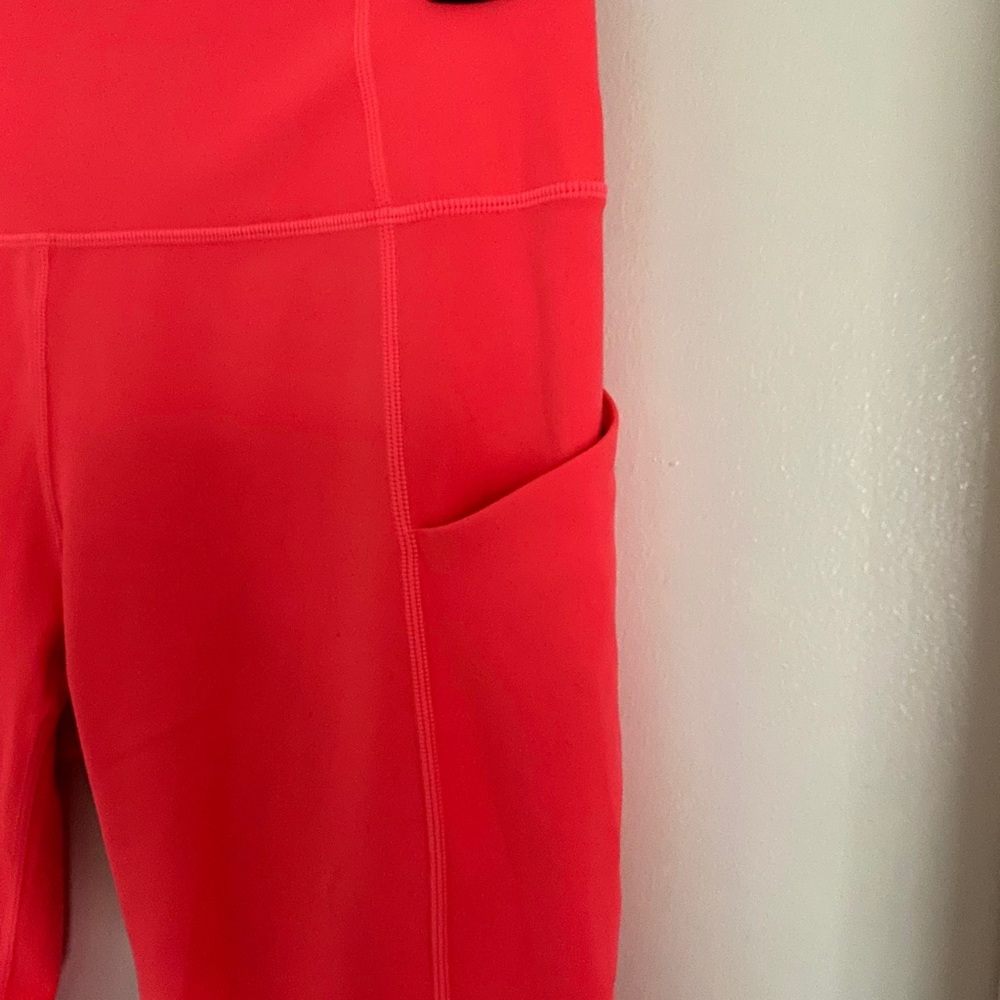 Pink Fabletics capri pocket leggings.